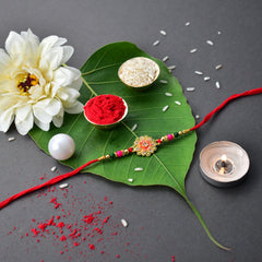 Green And Red Flower Rakhi With Ganesha Pooja Thali Set ,Silver Color Pooja Coin, Roli Chawal & Greeting Card