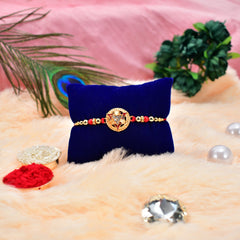 Round Rakhi With Trangal In Middle With Decorative Baby Buddha Gift ,Silver Color Pooja Coin, Roli Chawal & Greeting Card