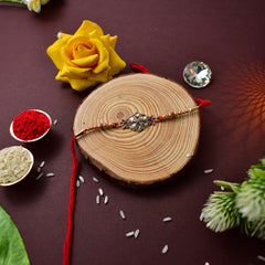 Flower Diamond Rakhi With Red And Blue Mina With Ganesha Pooja Thali Set ,Silver Color Pooja Coin, Roli Chawal & Greeting Card