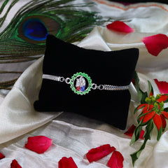 Radha Krishan In Circle Bracelet With Effete Choco Almond Chocolate 32Gm ,Silver Color Pooja Coin, Roli Chawal & Greeting Card