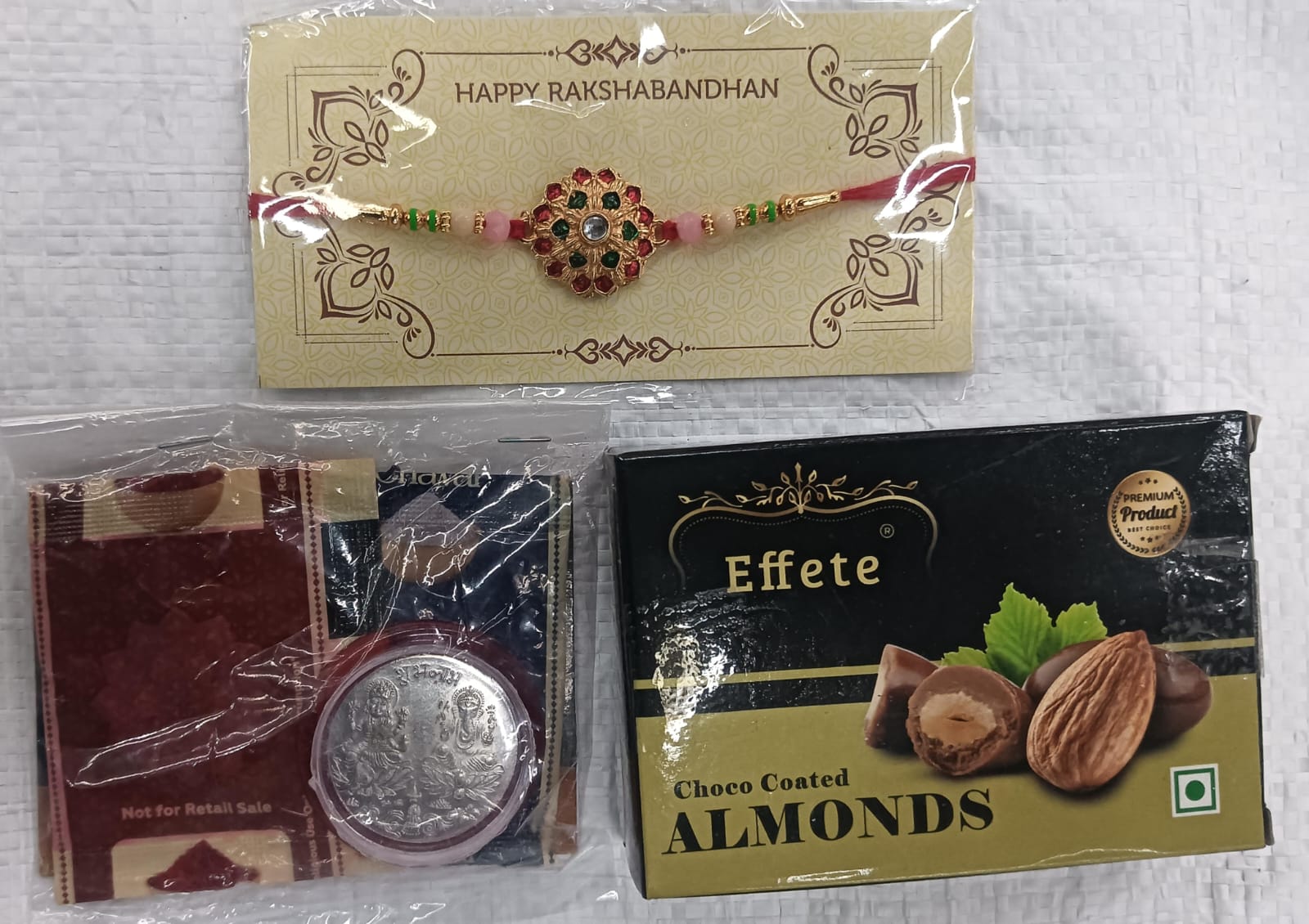 Premium Rakhi Gift Combo with Floral Rakhi, Choco Coated Almonds, Silver Coin, Tilak Set & Greeting Card for Brother
